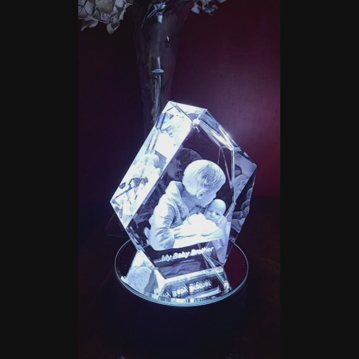video of a 3d prestige - iceberg shape crystal spinning on a rotating light base