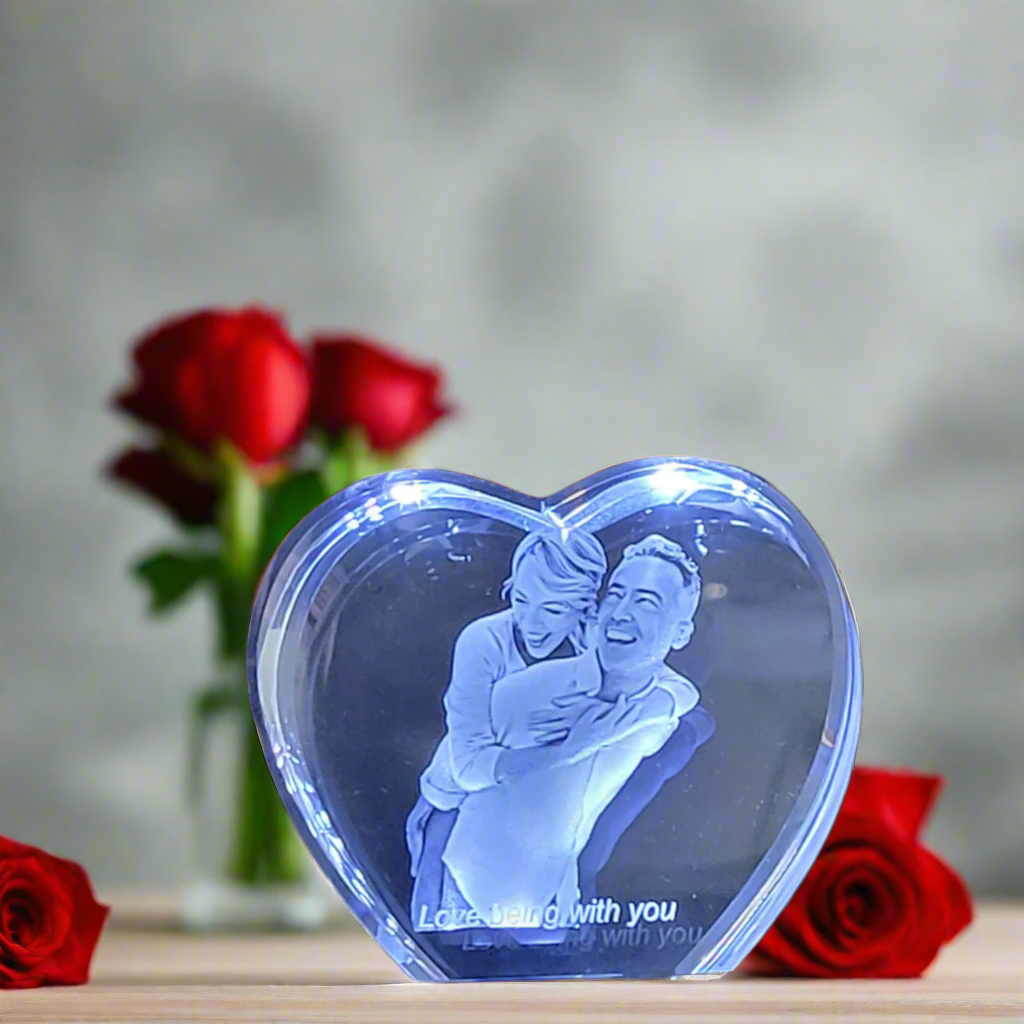 Picture of a 3d crystal heart with roses in the background 