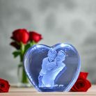 Picture of a 3d crystal heart with roses in the background 